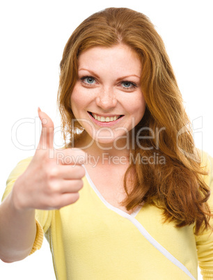 Woman is showing thumb up gesture