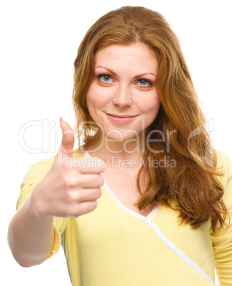 Woman is showing thumb up gesture