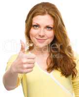 Woman is showing thumb up gesture