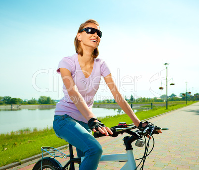 Young woman is sitting on her bicycle