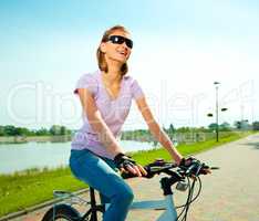 Young woman is sitting on her bicycle