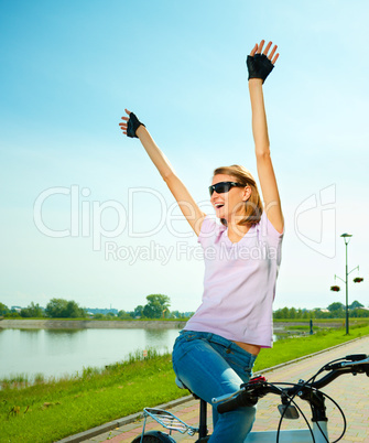 Young woman is sitting on her bicycle