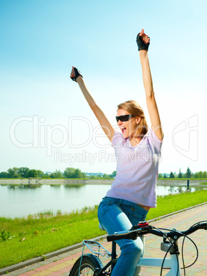 Young woman is sitting on her bicycle