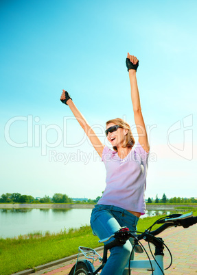 Young woman is sitting on her bicycle