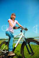 Young woman is sitting on her bicycle