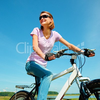 Young woman is sitting on her bicycle