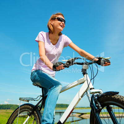 Young woman is sitting on her bicycle