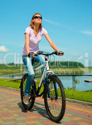 Young woman is sitting on her bicycle