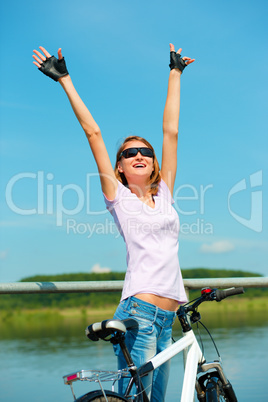 Young woman raised her hands up in joy