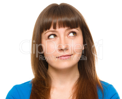 Young happy woman is looking up and smile