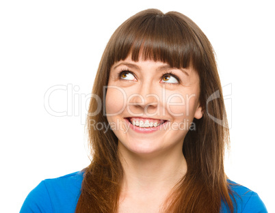 Young happy woman is looking up and smile