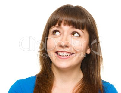 Young happy woman is looking up and smile