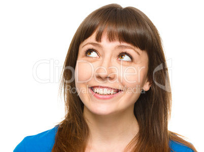 Young happy woman is looking up and smile