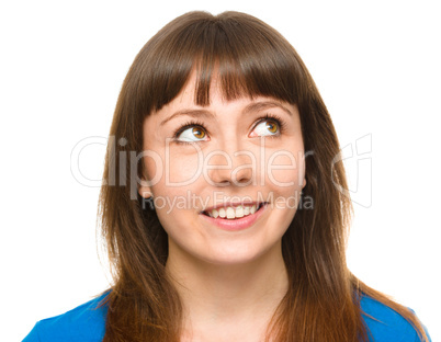 Young happy woman is looking up and smile