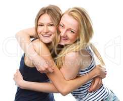 Two young women are hugging as a best friends