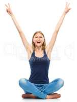 Young woman is raised her hands up in joy