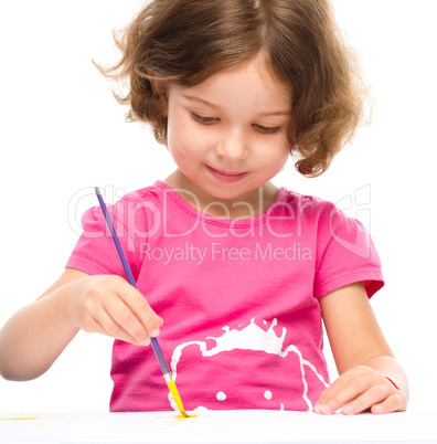 Little girl is painting with gouache