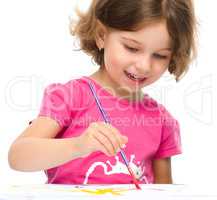 Little girl is painting with gouache