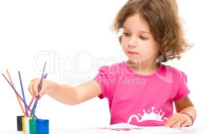 Little girl is painting with gouache Little girl is painting with gouache