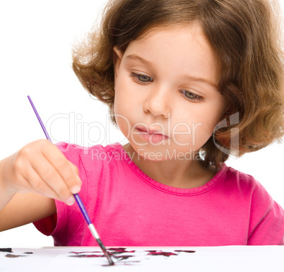 Little girl is painting with gouache