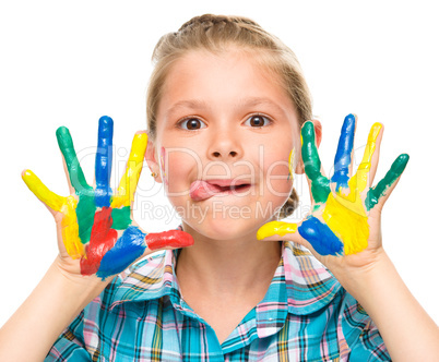 Portrait of a cute girl playing with paints