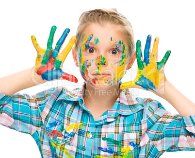 Portrait of a cute girl playing with paints