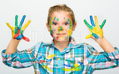 Portrait of a cute girl playing with paints