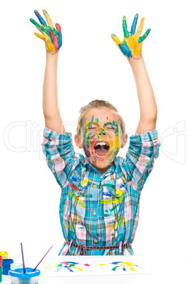 Little girl is rising her hands up in joy