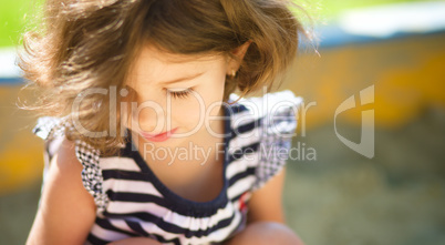 Cute little girl is playing in playground