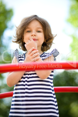 Cute little girl is playing in playground