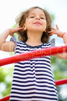 Cute little girl is playing in playground