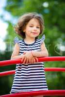 Cute little girl is playing in playground