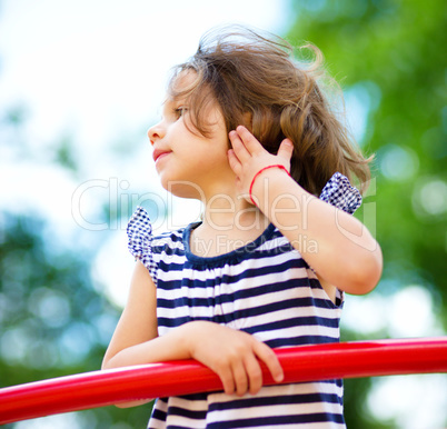 Cute little girl is playing in playground