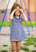 Cute little girl is playing in playground