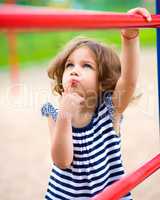 Cute little girl is playing in playground