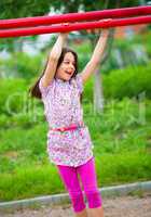 Cute little girl is playing in playground