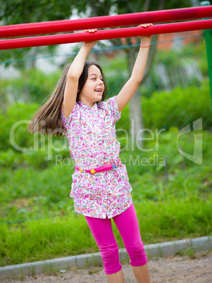 Cute little girl is playing in playground