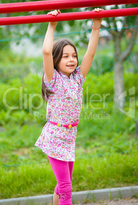 Cute little girl is playing in playground