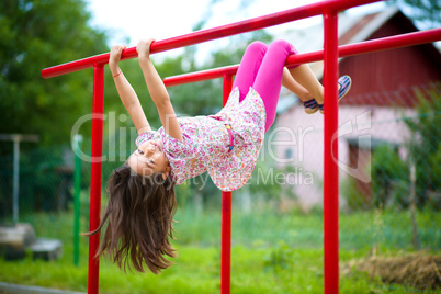 Cute little girl is playing in playground