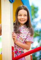 Cute little girl is playing in playground