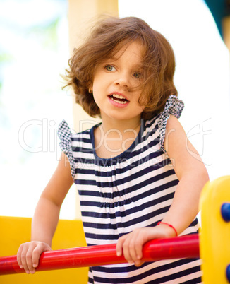 Cute little girl is playing in playground