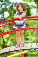 Cute little girl is playing in playground