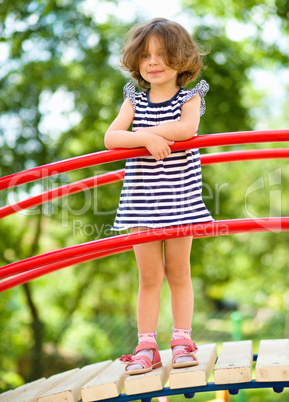 Cute little girl is playing in playground