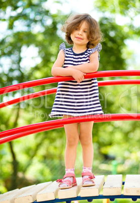 Cute little girl is playing in playground