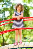 Cute little girl is playing in playground