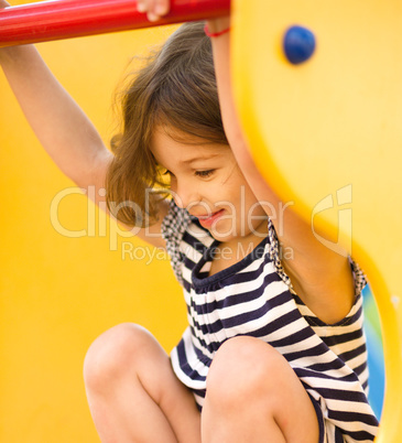 Cute little girl is playing in playground