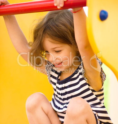 Cute little girl is playing in playground