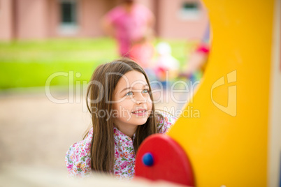 Cute little girl is playing in playground