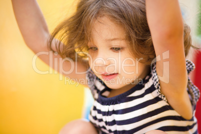 Cute little girl is playing in playground