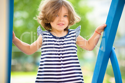 Cute little girl is playing in playground